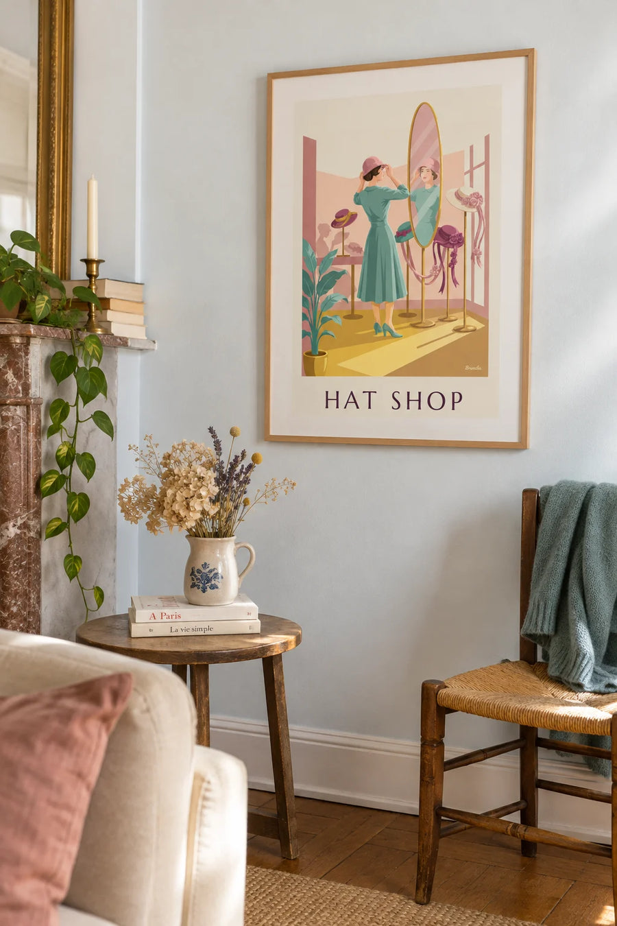 Poster of a woman trying on a hat at the milliner’s: framed on the wall