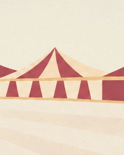 A red and cream striped big top behind the pale circus ring