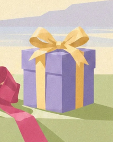 La boîte cadeau mauve entourée d’un ruban jaune et coiffée d’un grand nœud