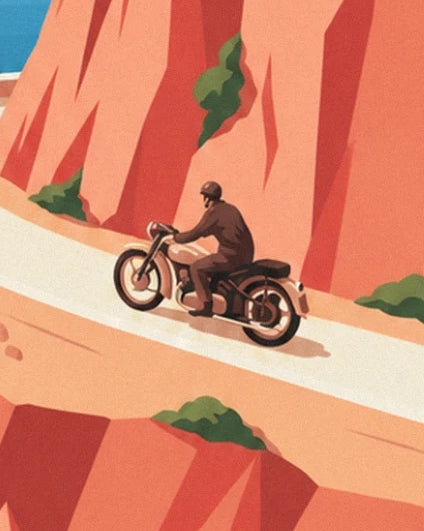 The rider in brown on his motorbike, between the orange cliffs of Estérel