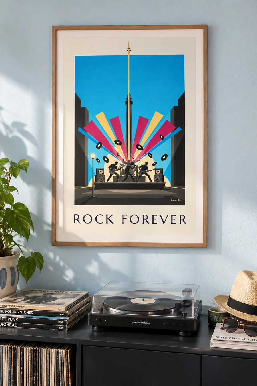 Poster of rock musician silhouettes on stage and vinyl records: framed on the wall