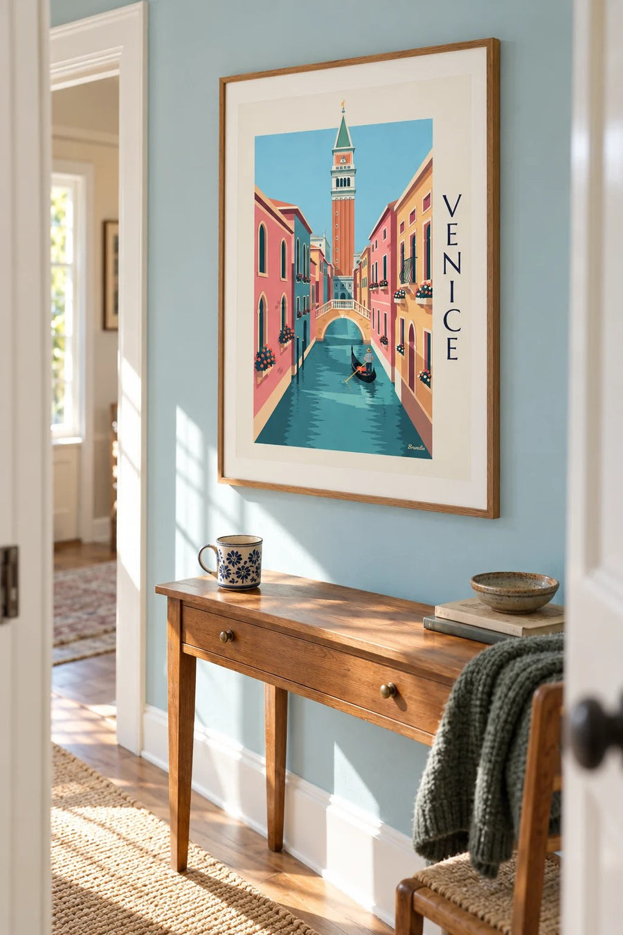 Gondolier on a small canal under the Venice Campanile poster: framed on the wall