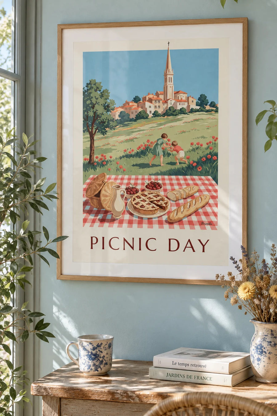 Poster of a family picnic on a checkered tablecloth: framed on the wall