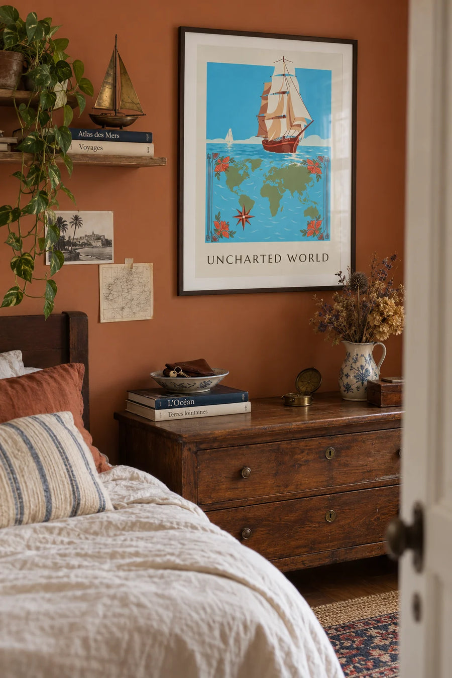 Poster of an explorers’ world map with sailing ships and a compass rose: framed on the wall