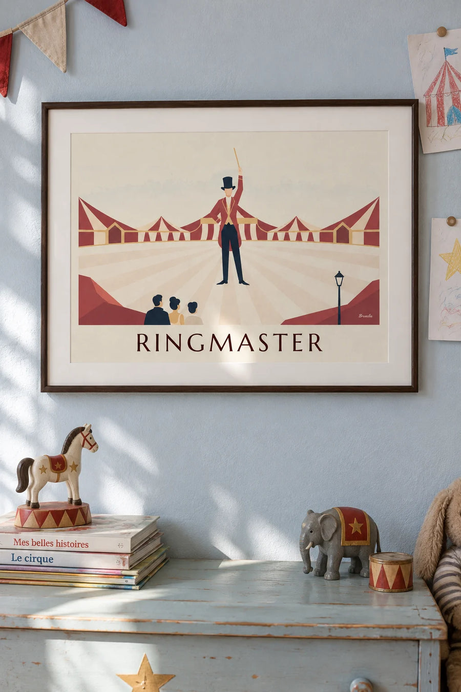 Poster of a ringmaster in a red tailcoat and top hat: framed on the wall