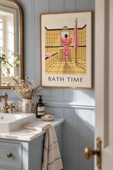 Poster of a woman in a pink robe in a yellow bathroom: framed on the wall