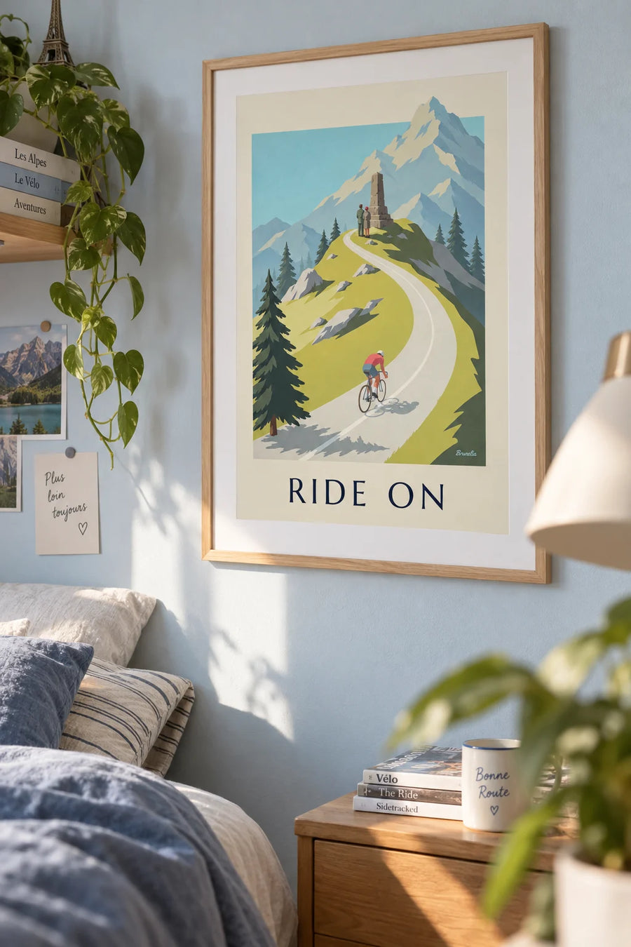 Poster of a cyclist climbing a mountain pass: framed on the wall